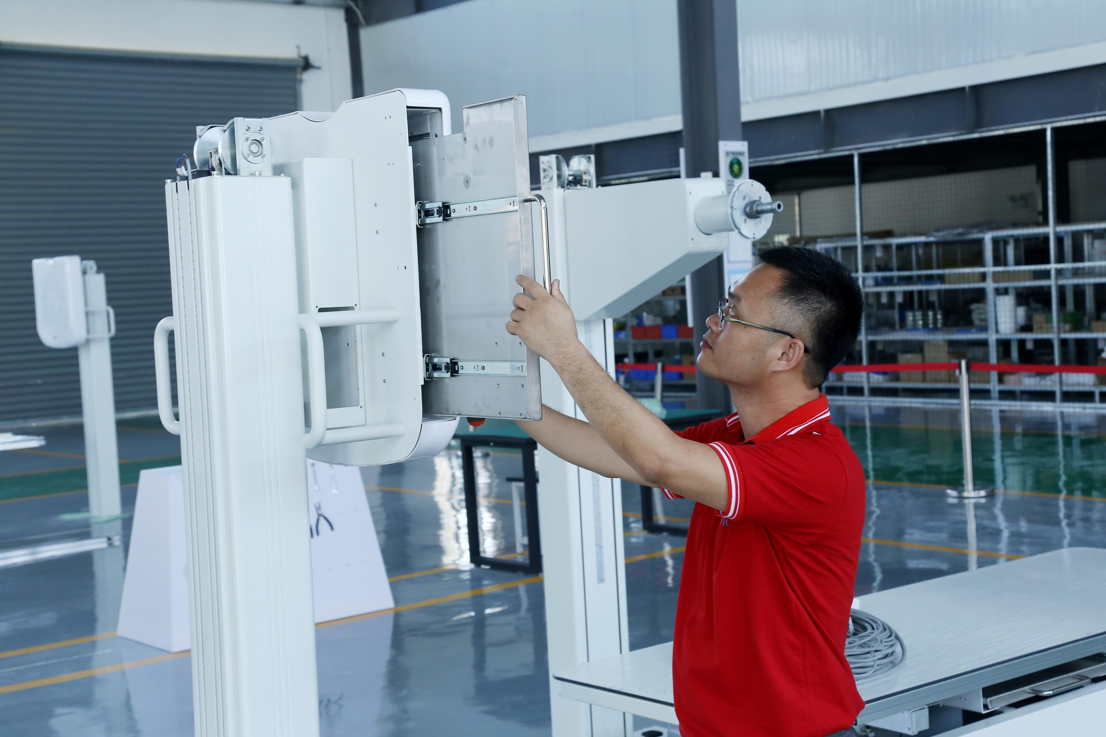 Technician working on medical imaging equipment at the Hubei facility